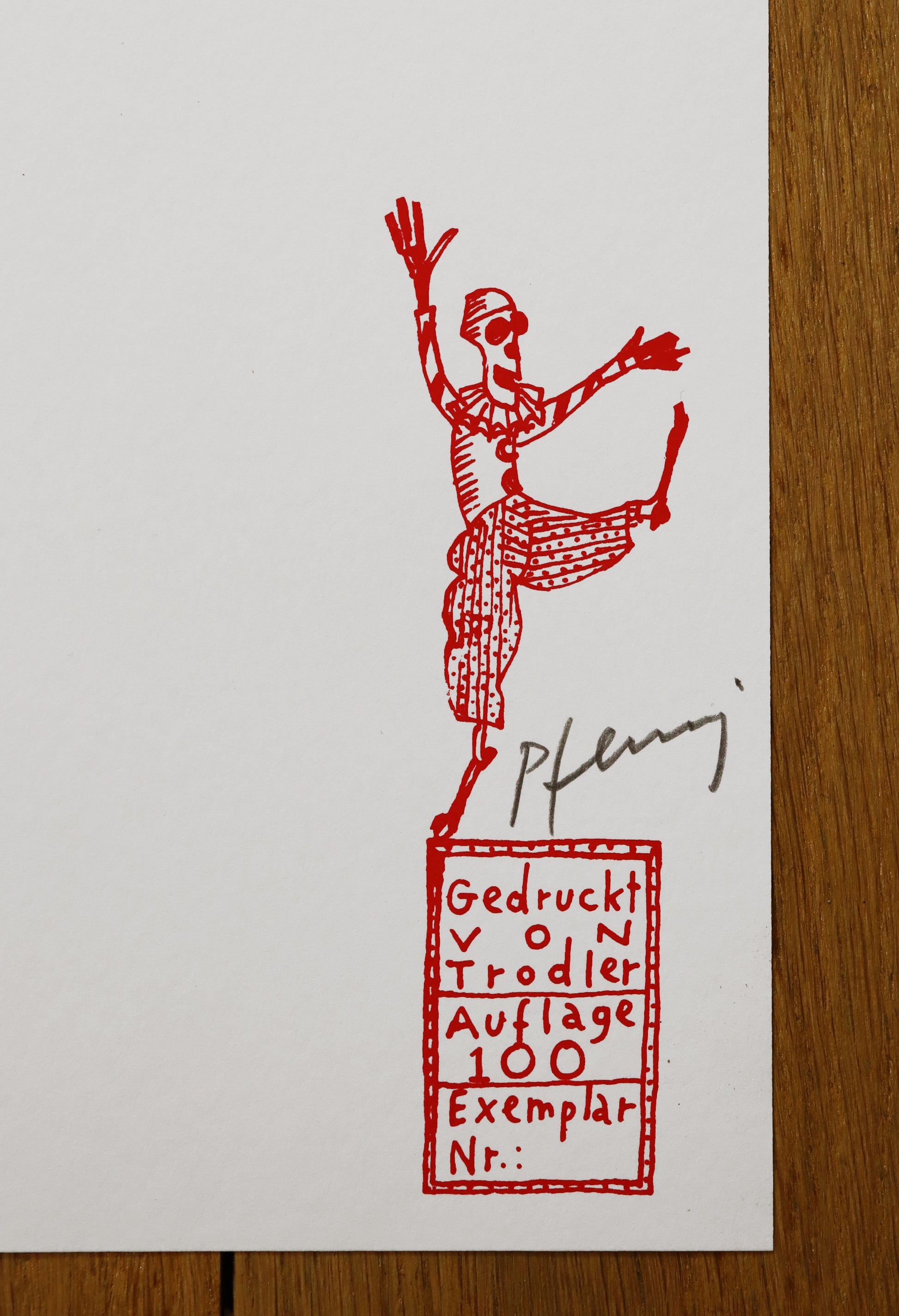 Druck Edition Trodler, von Wolf-Dieter Pfennig, Titel „Der Tod ist groß“ – Detailaufnahme der Vignette von Trodler und Originalsignatur von Pfennig, in rot, Galerie Waldbach - What The Artist Made